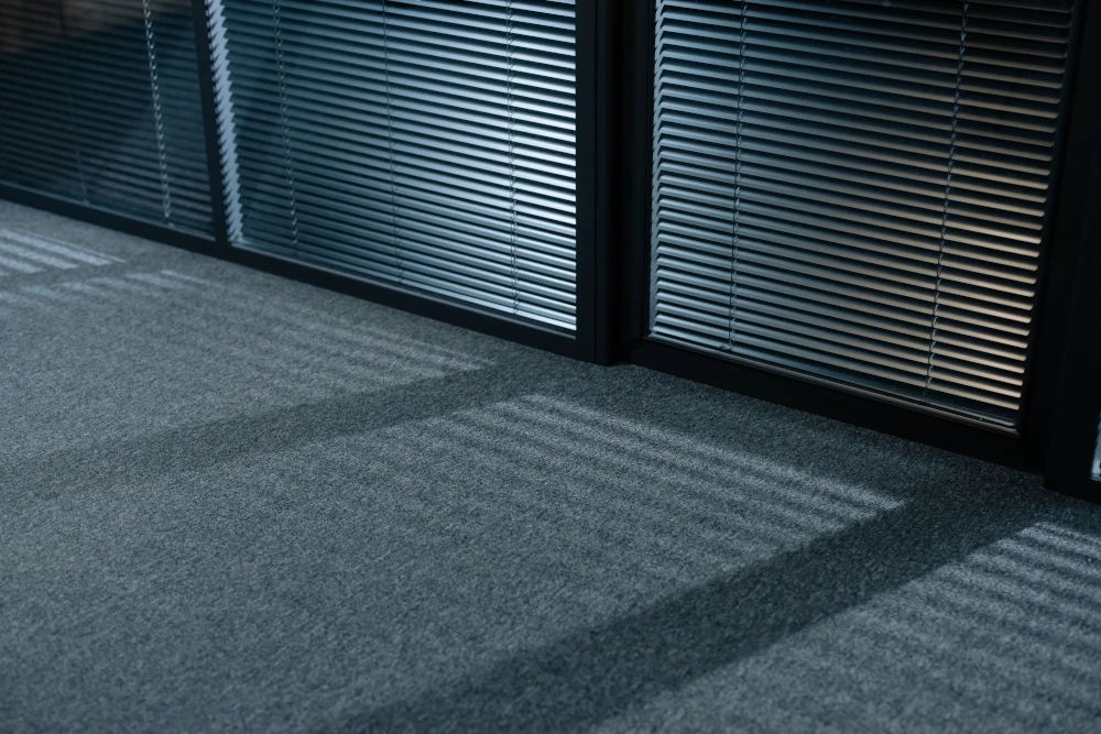 A dark room with black blinds.